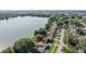 An aerial view showcases the homes near a beautiful lake and lush greenery at 2743 Grandola Dr, Orlando, FL 32811