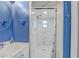 Bathroom featuring a walk-in shower with blue accents and a modern vanity at 2743 Grandola Dr, Orlando, FL 32811