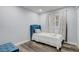 Cozy bedroom with a single bed, soft lighting, a tufted accent ottoman and wood-look flooring at 2743 Grandola Dr, Orlando, FL 32811