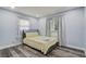 Cozy bedroom with wood floors, soft bedding, and natural light from the window at 2743 Grandola Dr, Orlando, FL 32811