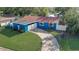 Aerial view of the home with a curved drive, small lawn, and blue painted exterior at 2743 Grandola Dr, Orlando, FL 32811