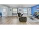 Spacious open living area with wood floors, large windows and comfortable furniture at 2743 Grandola Dr, Orlando, FL 32811