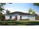 Charming single-story home with a well-manicured lawn and beautiful landscaping at 313 Marquee Dr, Kissimmee, FL 34758