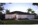 Charming single-story home with a well-manicured lawn and beautiful landscaping at 313 Marquee Dr, Kissimmee, FL 34758