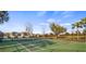 Outdoor tennis court with green surface and surrounding fencing at 3267 Landing Vw, Tavares, FL 32778