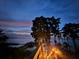 A waterfront view features stairs leading to the water under the twilight sky at 3267 Landing Vw, Tavares, FL 32778