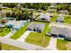 Aerial view of a home with a paved driveway, landscaped yard, and well-maintained neighborhood at 3324 Sw 137Th Loop, Ocala, FL 34473
