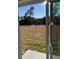 A view of the lawn from the glass doors overlooking the backyard at 3324 Sw 137Th Loop, Ocala, FL 34473