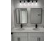 Bathroom boasts a double vanity with quartz countertop and sleek black fixtures at 3324 Sw 137Th Loop, Ocala, FL 34473
