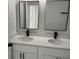 Modern bathroom features double vanity with quartz countertop and sleek black faucets at 3324 Sw 137Th Loop, Ocala, FL 34473