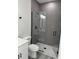 Bathroom showcasing a walk-in shower with gray tile, geometric floor tile, and a glass door at 3324 Sw 137Th Loop, Ocala, FL 34473