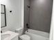 Bathroom showcasing modern white vanity, shower and tub combo with neutral tiling, and sleek black fixtures at 3324 Sw 137Th Loop, Ocala, FL 34473