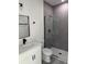 Bathroom featuring stylish gray tile, a glass-enclosed shower, modern vanity, and sleek fixtures at 3324 Sw 137Th Loop, Ocala, FL 34473