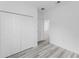 Bright bedroom with closet and gray wood-look flooring at 3324 Sw 137Th Loop, Ocala, FL 34473