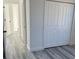 Bedroom featuring a double door closet, light gray walls, and neutral vinyl flooring at 3324 Sw 137Th Loop, Ocala, FL 34473