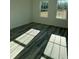 Bright bedroom features two windows and durable gray-toned flooring at 3324 Sw 137Th Loop, Ocala, FL 34473