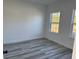 Bedroom featuring two windows providing light and attractive gray-toned flooring at 3324 Sw 137Th Loop, Ocala, FL 34473