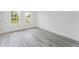 A bright bedroom with wood-look floors and two windows at 3324 Sw 137Th Loop, Ocala, FL 34473