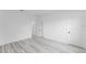 A bedroom with wood-look floors, walk in closet and entry to another room at 3324 Sw 137Th Loop, Ocala, FL 34473