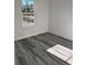 Bedroom features a window providing natural light and attractive gray-toned flooring at 3324 Sw 137Th Loop, Ocala, FL 34473