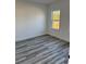 Bedroom with window offering plenty of light and stylish gray-toned flooring at 3324 Sw 137Th Loop, Ocala, FL 34473