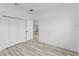 A bedroom with wood-look floors and a double door closet at 3324 Sw 137Th Loop, Ocala, FL 34473