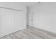 A bedroom with wood-look floors and a double door closet at 3324 Sw 137Th Loop, Ocala, FL 34473