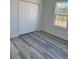 Bedroom featuring a closet, window, and stylish gray-toned flooring at 3324 Sw 137Th Loop, Ocala, FL 34473