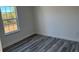 Bedroom with window offering plenty of light and stylish gray-toned flooring at 3324 Sw 137Th Loop, Ocala, FL 34473
