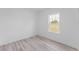 This bedroom features wood-look floors and a window with outdoor views at 3324 Sw 137Th Loop, Ocala, FL 34473