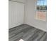 Bedroom features a window, closet, and stylish gray-toned flooring at 3324 Sw 137Th Loop, Ocala, FL 34473