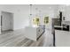 Modern kitchen featuring an island, stainless appliances, white countertops, and gray wood-look flooring at 3324 Sw 137Th Loop, Ocala, FL 34473