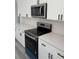 Modern kitchen with stainless steel appliances, granite countertops, and sleek hardware at 3324 Sw 137Th Loop, Ocala, FL 34473