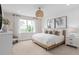 Well-lit bedroom with a woven pendant, light wood accents, and large windows at 3427 Orange Rose Loop, Apopka, FL 32712