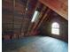 Unfinished attic space with wooden walls and floors, a window, and a skylight offers potential for customization at 3471 Whitner Way, Sanford, FL 32773