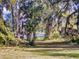 View of lush backyard lawn surrounded by mature trees at 3471 Whitner Way, Sanford, FL 32773