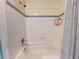 A standard bathtub and shower combo with white tile and simple decor at 3471 Whitner Way, Sanford, FL 32773