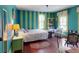 Vibrant bedroom with unique striped walls, offering a cozy bed and natural light from the windows at 3471 Whitner Way, Sanford, FL 32773