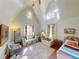 Spacious bedroom with vaulted ceilings, natural light, and colorful vintage furnishings. A cozy retreat at 3471 Whitner Way, Sanford, FL 32773