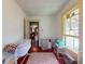Bright bedroom features a crib by the window, with natural light, offering a versatile space at 3471 Whitner Way, Sanford, FL 32773