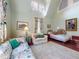 Sunlit bedroom with high ceilings, comfortable seating, and a vintage rug. An inviting relaxation space at 3471 Whitner Way, Sanford, FL 32773
