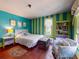 Vibrant bedroom featuring striped walls, hardwood floors, and abundant natural light, creating a cheerful space at 3471 Whitner Way, Sanford, FL 32773