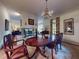 Elegant dining room with grand table, chandelier, and seamless transition to living area at 3471 Whitner Way, Sanford, FL 32773