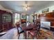 Dining room featuring a large wooden table, colorful rug, and fireplace with wooden mantle at 3471 Whitner Way, Sanford, FL 32773