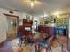 Dining room featuring a large wooden table, colorful rug, and kitchen with stainless steel refrigerator at 3471 Whitner Way, Sanford, FL 32773