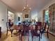 Formal dining room with chandelier, large table, and views into the living room at 3471 Whitner Way, Sanford, FL 32773