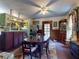 Dining room featuring a large wooden table, colorful rug, and wooden paneled wall with glass door at 3471 Whitner Way, Sanford, FL 32773