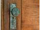 Close-up of an antique doorknob on a wooden door, showcasing intricate detailing and vintage charm at 3471 Whitner Way, Sanford, FL 32773