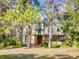 Charming yellow two-story home with Queen Anne architecture, a quaint porch, and a lush green front lawn at 3471 Whitner Way, Sanford, FL 32773