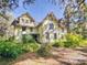 A two-story home with lush landscaping and trees surrounding it at 3471 Whitner Way, Sanford, FL 32773